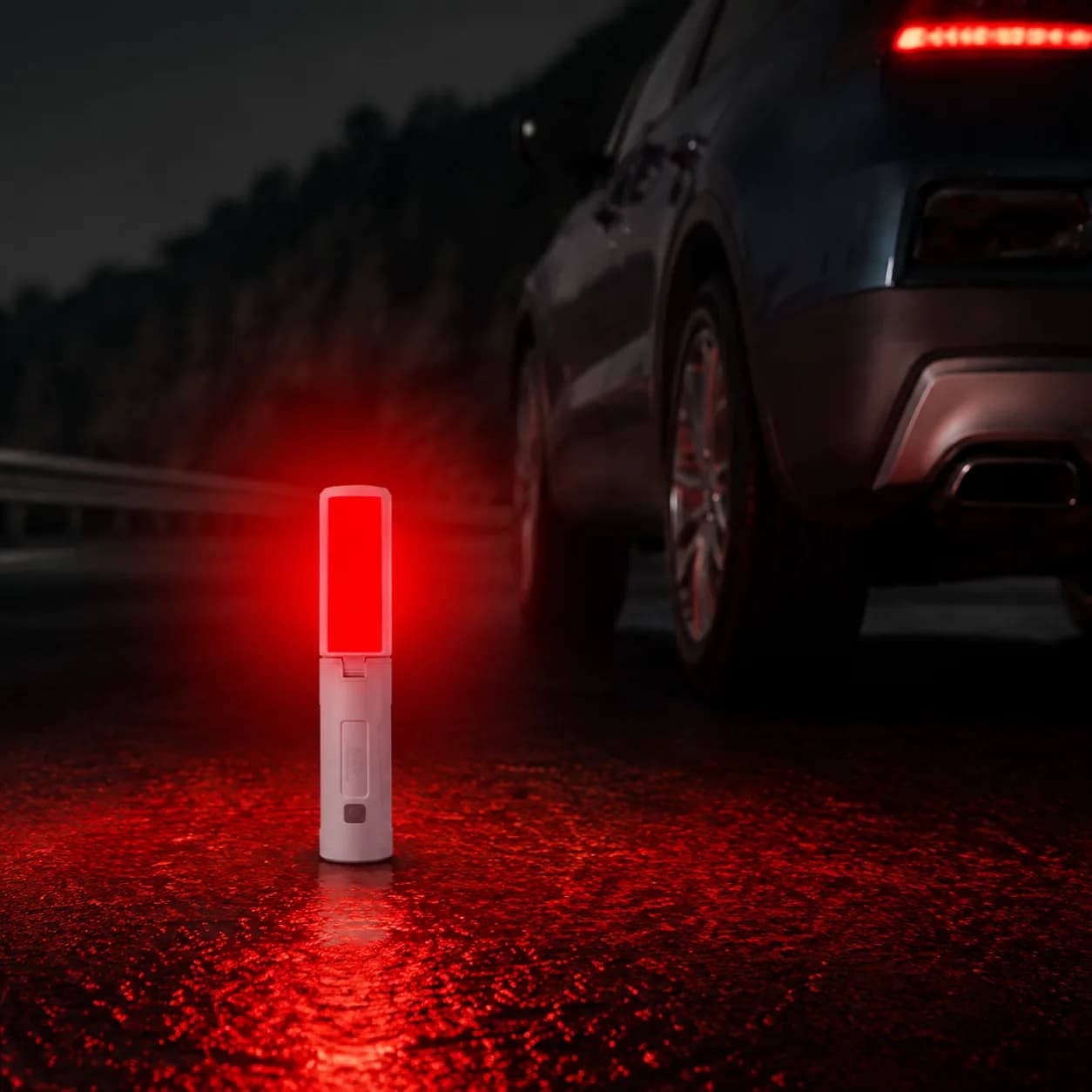 M26 camping light in red warning mode beside a vehicle